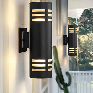 Black modern wall light fixture mounted on a white outdoor wall