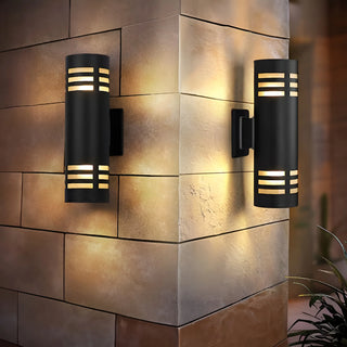 Modern dual-beam wall lights mounted on a brick corner wall, emitting warm light