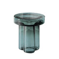 Emerald green sculptural glass side table isolated on light background