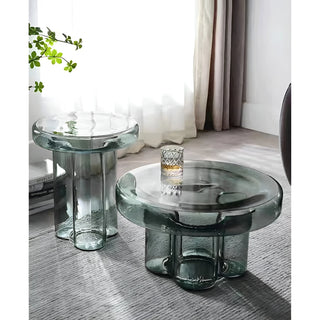 Emerald green sculptural glass side table set styled in modern living room interior