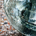 Close-up detail of emerald green textured organic glass tabletop surface