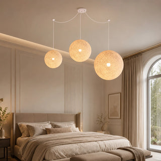 Filara woven ball pendant lighting a neutral bedroom above an upholstered bed