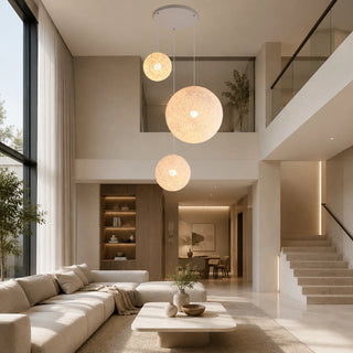 Filara woven ball pendant in a bright double-height living space with a staircase