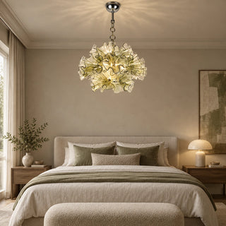 Fiorvella ruffled glass chandelier above a bed in a neutral bedroom