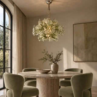 Fiorvella glass flower chandelier above a round dining table with green upholstered chairs