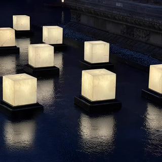 Waterproof marble-effect cube lamps illuminating a reflective pool -premium exterior lighting by Mirodemi