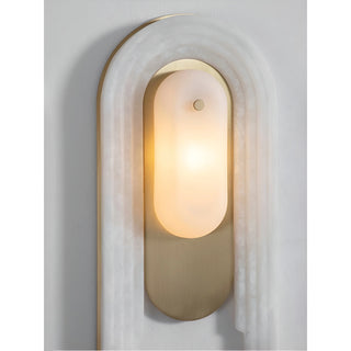 Front view of the luxury wall sconce with white frosted glass, brushed brass, and carved marble frame
