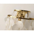 Close-up of the gold-finished frame with handcrafted capiz shell discs suspended in elegant cascading layers