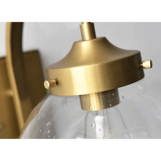 Close-up of gold electroplated finish on outdoor wall sconce, showing fine brushed aluminum and textured glass globe