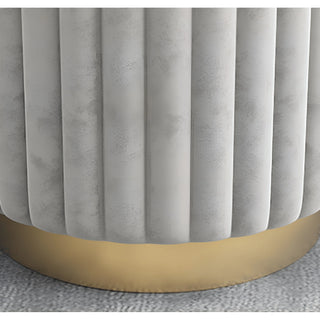 Close-up of gray velvet ottoman base with golden metal ring — modern Nordic design