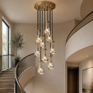 Guttara 9-light raindrop chandelier over a curved staircase entry