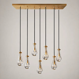 Guttara rectangular 7-light raindrop chandelier on a brass linear canopy, studio view
