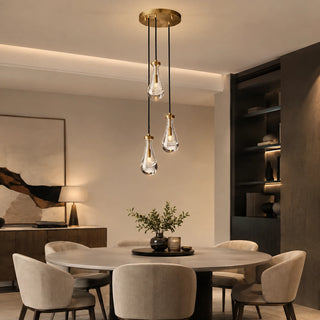 Guttara round 3-light raindrop pendant over a round dining table