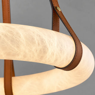 Close-up of a Halara tan leather strap wrapping the glowing natural alabaster ring