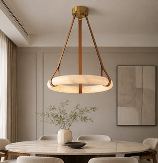 Halara alabaster ring chandelier lighting a modern dining room with a marble table