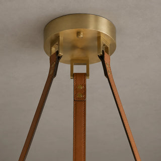 Detail of the Halara brushed brass canopy and riveted tan leather straps