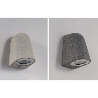 White and black sandstone wall sconces showcasing smooth handcrafted microcement finish