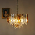 Illuminated amber and clear Murano glass chandelier with warm decorative lighting