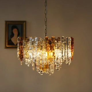 Illuminated amber and clear Murano glass chandelier with warm decorative lighting