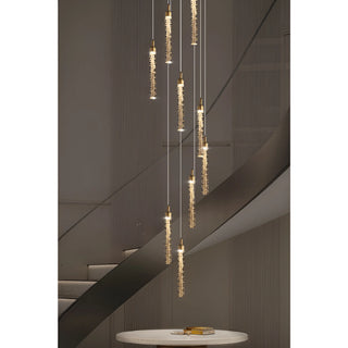 Kaelix modern crystal pendant lighting suspended above a contemporary staircase with adjustable cables