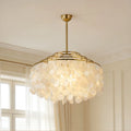 Large capiz shell chandelier hanging above dining area in modern luxury home