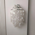 Large chrome Capiz Shell Wall Sconce featuring handcrafted capiz shell discs and a tiered metal frame mounted on a wall