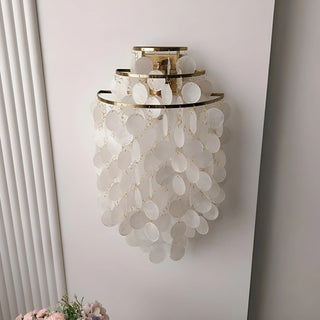 Large gold Capiz Shell Wall Sconce with cascading natural shell discs mounted on a wall in a modern interior