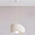 large asymmetrical white pendant light with soft textured surface and warm light, hanging from ceiling in minimalist neutral space