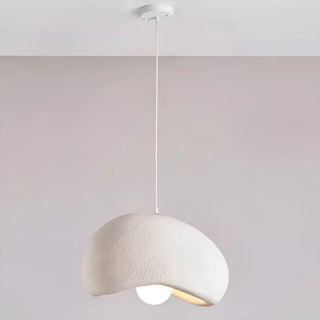 large asymmetrical white pendant light with soft textured surface and warm light, hanging from ceiling in minimalist neutral space