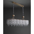 Turned off angled view of clear K9 crystal dining chandelier with gold ceiling mount and adjustable suspension rods