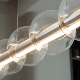 Close-up of transparent glass globes on the Nordic linear pendant light