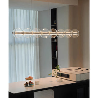 Nordic glass chandelier above a cozy dining setting in bright interior