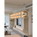 Linear Glass Pendant Light illuminating a modern living room area