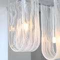 Liora linear pendant light multiple clear glass shades illuminated close-up