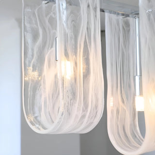 Liora linear pendant light multiple clear glass shades illuminated close-up