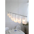 Liora linear pendant light installed above dining table modern interior