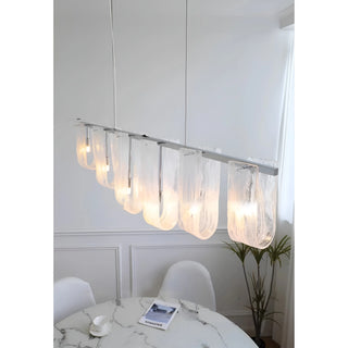 Liora linear pendant light installed above dining table modern interior