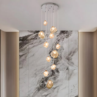 Amber rock glass cascade chandelier styled against a grey marble feature wall in a modern foyer