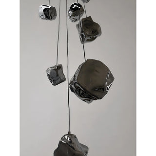 Close-up of smoky mirrored rock glass pendants on the Lithara cascade chandelier