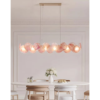 Blush Pink Lumière Éclat rectangular chandelier installed above oval dining table in elegant modern interior