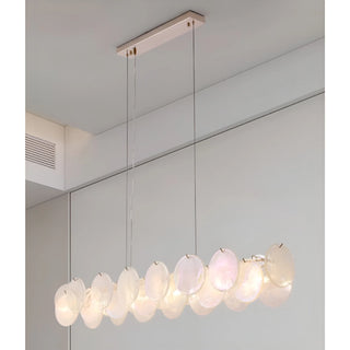 Soft White Lumière Éclat rectangular chandelier illuminated, showcasing layered glass discs and soft diffused glow