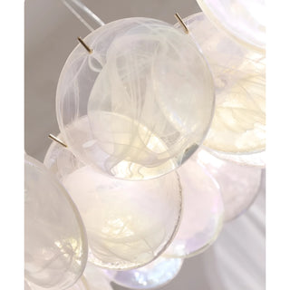 Close-up of Lumière Éclat rectangular glass disc chandelier in White Opal finish with textured translucent glass panels and brass frame