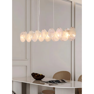 Lumière Éclat rectangular glass chandelier in Soft White finish hanging above contemporary dining table