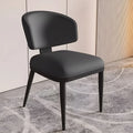 Elegant black leather dining chair with ergonomic backrest and tapered legs