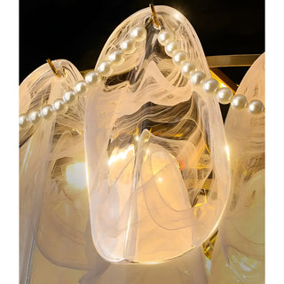 Luxury glass chandelier with pearl accent detailing and warm ambient lighting