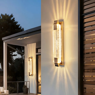 Crystal LED outdoor wall sconce illuminating a modern villa facade at dusk
