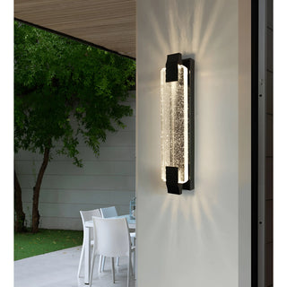 rystal LED wall light installed beside a white modern patio dining area
