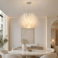 Lysara Tiered Crystal Leaf Chandelier installed above a modern dining table in a luxury dining room