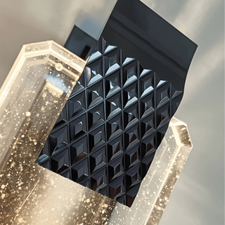 Close-up of black diamond-cut metal accent and bubble glass texture