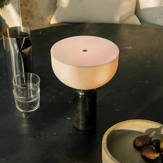 Marble cordless rechargeable table lamp creating warm ambient lighting on a modern table